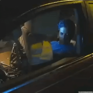 This meme uses a forced perspective optical illusion for humorous effect. A scene from the 2011 film *Drive* showing Ryan Gosling as the Driver sitting in a car is visible through a real car window. A person standing outside the physical car has pressed their leg against the window, creating the illusion that a large, disembodied leg is sitting in the passenger seat next to Gosling in the movie scene. Gosling's character appears to look directly at the fake leg with a slightly alarmed neutral expression, paired with the title "I'd run for my life" to emphasize the absurd, unsettling vibe of the gag.