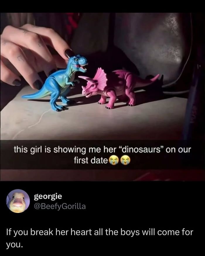 This is a screenshot of a social media post showing a woman's tattooed hand with black nail polish next to two toy dinosaurs: a blue Tyrannosaurus Rex and a pink Triceratops. The overlaid text from the original dater says 'this girl is showing me her "dinosaurs" on our first date' with crying emoticons. A comment from another user replies 'If you break her heart all the boys will come for you.' The meme captures a wholesome, endearing moment where the girl's innocent cute hobby of collecting dinosaur toys makes the internet community rally to protect her, leaning into the 'she's a keeper' vibe.