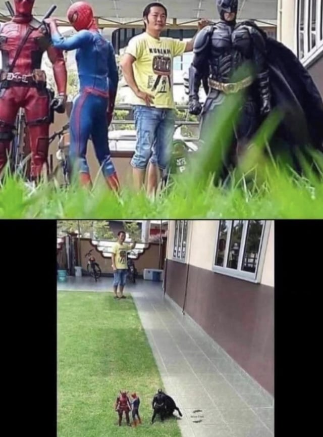 A two-panel meme utilizing forced perspective photography. The top panel presents a man in a yellow t-shirt and blue jeans standing casually with his hands on hips, seemingly flanked by three life-sized superheroes: Deadpool (red suit with black accents), Spider-Man (blue suit with red details), and Batman (black suit with a cape). The scene is set outdoors with green grass in the foreground, creating the illusion that the superheroes are full-sized. The bottom panel reveals the trick: the man is actually in a normal outdoor area, and the 'superheroes' are small action figures placed on the ground near his feet, with the camera angle in the top panel creating the misleading perspective of them being life-sized companions.