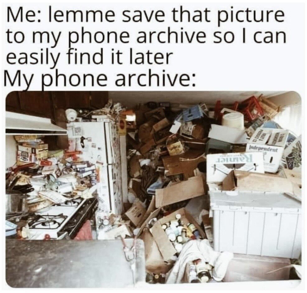 This relatable humor meme has text at the top stating the user's intention: 'Me: lemme save that picture to my phone archive so I can easily find it later', followed by 'My phone archive:'. Below the text is a photograph of an extremely cluttered, disorganized messy room filled with scattered household items, boxes, appliances, papers, and random miscellaneous objects, used as a humorous metaphor for how unorganized and impossible to navigate most people's saved phone photo galleries are, making the goal of easily finding the saved image later unachievable.