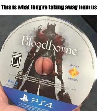 The meme features a photograph of a physical PlayStation 4 Bloodborne game disc held by a person. Text at the top of the image reads 'This is what they're taking away from us'. A visual pun is created by the central hole of the disc aligning perfectly between the legs of the Hunter protagonist on the official Bloodborne disc art, making it appear as though the character has a visible butt crack. The joke references the long-running frustration of Bloodborne fans, as Sony has not released a PC port, remaster, or sequel for the beloved PS4 exclusive game for nearly a decade, leading fans to joke that Sony is intentionally keeping the game (and the silly visual gag) away from wider audiences.
