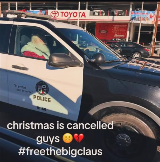The image depicts a white and black police SUV with the text "To protect and to serve" and "POLICE" visible on the side. Inside the driver's seat is a person dressed as Santa Claus, wearing the iconic red suit and white beard. In the background, there is a Toyota dealership with a visible "TOYOTA" sign. Overlaid on the bottom of the image is the text: "christmas is cancelled guys 😔💔 #freethebigclaus". The meme humorously suggests that Santa has been arrested, leading to the cancellation of Christmas, with a playful hashtag advocating for his release.