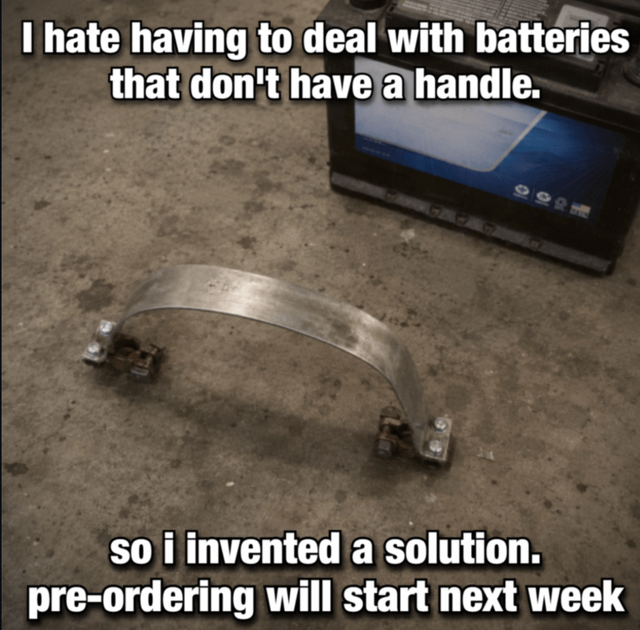This meme displays a concrete garage work surface, with a handle-less car battery visible in the upper right corner. In the center foreground is a scrappy DIY contraption made of a bent flat metal strap attached to two car battery terminal clamps on each end, designed to act as a carrying handle for batteries that do not have built-in handles. The overlaid text reads first: 'I hate having to deal with batteries that don't have a handle.', followed by 'so i invented a solution. pre-ordering will start next week'. The joke lies in the relatable resourcefulness of mechanics creating simple, low-effort solutions to common frustrating work problems, plus the sarcastic line about pre-orders framing the cheap DIY tool as a fancy new commercial product.