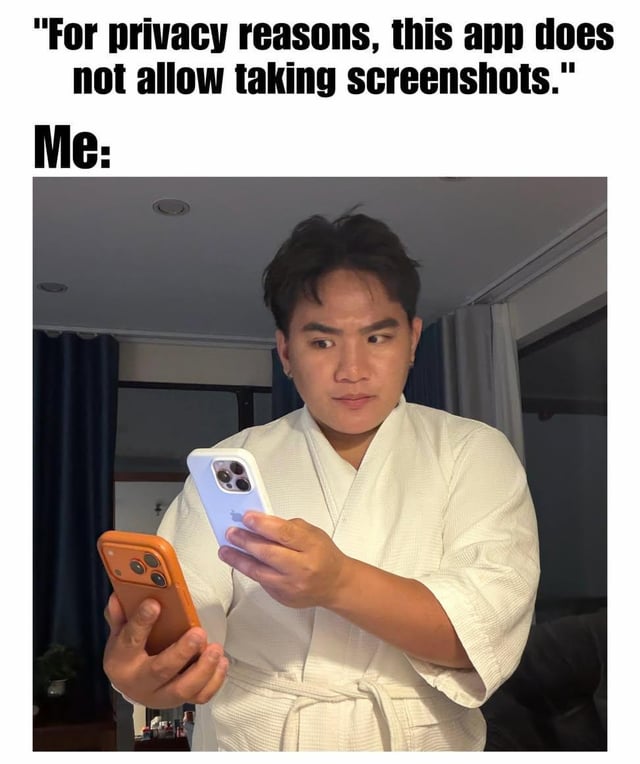 The meme is split into text and photo sections. The top of the meme has text stating a common app notification: "For privacy reasons, this app does not allow taking screenshots.", followed by the label "Me:". Below this text is a photograph of an East Asian man wearing a white bathrobe indoors, holding two smartphones: he uses an orange-cased iPhone in his left hand to take a physical photo of the screen of a white-cased iPhone in his right hand, working around the app's screenshot block. The joke plays on the idea of using a simple, low-tech 'ancient' solution to a modern tech restriction, as referenced in the original post title.