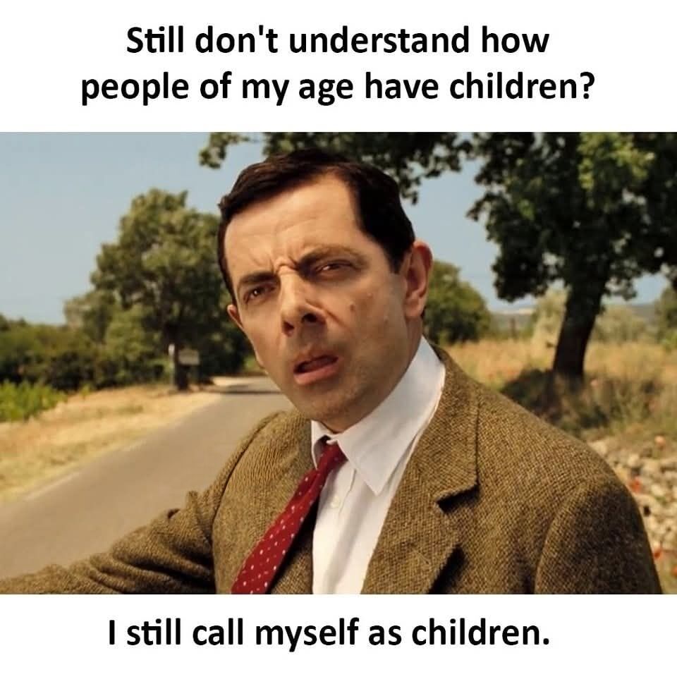 This single-panel meme uses a well-known still of Rowan Atkinson portraying the character Mr. Bean, who is shown outdoors beside a rural road with a confused, disbelieving squinting expression. Text is overlaid at the top and bottom of the image: the top text reads 'Still don't understand how people of my age have children?' and the bottom text reads 'I still call myself as children.' The meme expresses a common relatable feeling among young and middle-aged adults who still perceive themselves as immature or childlike internally, even when they are chronologically old enough to have children, contrasting their own self-perception with peers who have already started families.