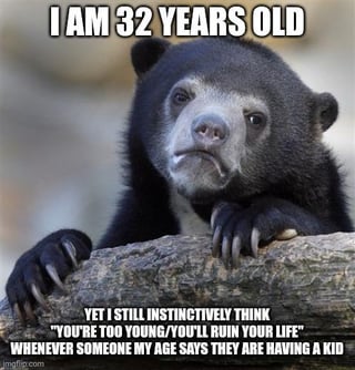 This is a classic Confession Bear format meme. It features a photograph of a sun bear leaning over a rock with a weary, resigned expression. The text overlaid on the image reads: top line "I AM 32 YEARS OLD", bottom block "YET I STILL INSTINCTIVELY THINK "YOU'RE TOO YOUNG/YOU'LL RUIN YOUR LIFE" WHENEVER SOMEONE MY AGE SAYS THEY ARE HAVING A KID". The joke relies on the extremely relatable adult experience of still feeling like you are not fully grown or mature enough for major life milestones, leading you to judge peers your own age as too young for those same milestones even though you are objectively the same appropriate age for them.