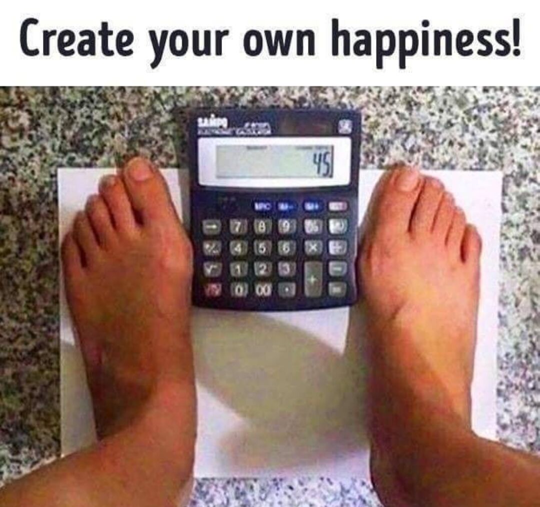 This humorous meme features text at the top reading 'Create your own happiness!'. Below the text, a first-person view shows a person's bare feet positioned on either side of a standard desktop calculator placed on a white sheet of paper on a speckled tile floor. The calculator's display is set to the number 45, making the setup look like a bathroom weighing scale showing an extremely low, desirable weight reading. The joke lies in the silly, harmless hack the person uses to avoid confronting their real weight, choosing instead to create their own positive, fake result to feel happy.