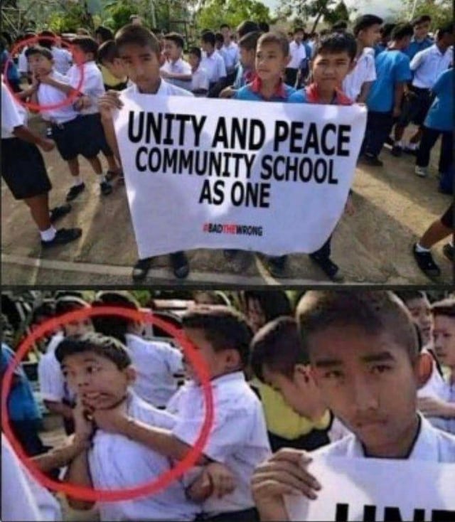 A two-panel meme image. The top panel depicts a group of school children, some wearing white shirts and dark shorts, gathered outdoors holding a large banner that reads 'UNITY AND PEACE COMMUNITY SCHOOL AS ONE'. A red circle is overlaid to draw attention to a child in the background. The bottom panel is a zoomed-in view of the circled area, revealing that the highlighted child is physically choking another child, creating a stark ironic contrast between the banner's message of peace and unity and the aggressive behavior shown.