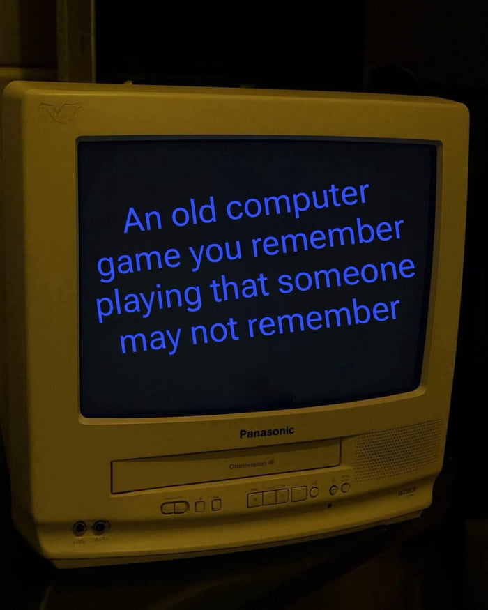 The image features a classic beige Panasonic CRT (cathode ray tube) monitor and TV combination unit photographed in a dim, dark environment. Displayed on the CRT's screen in light blue text against a black background is the sentence: 'An old computer game you remember playing that someone may not remember'. The image functions as a relatable nostalgia prompt targeting people who played retro computer games, asking them to recall and share niche or less widely known old games that they enjoyed growing up, which younger or less gaming-inclined people might not recognize.