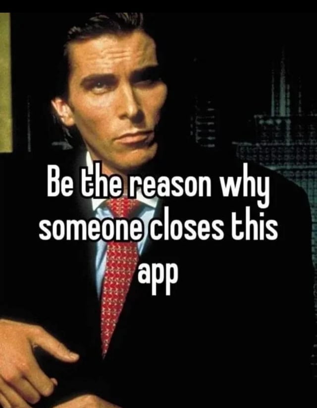 A meme featuring a screenshot of a man in a formal black suit with a red patterned tie, set against a dark background with a blurred cityscape visible behind him. The man has a serious, intense expression with furrowed brows and a neutral mouth, sitting with his right hand resting on his arm. Overlaid in bold white text across the lower half of the image is the phrase: 'Be the reason why someone closes this app'. The contrast between the man's stern demeanor and the sarcastic text creates a humorous effect, implying the person is so unappealing or boring that others would exit an app to avoid them.
