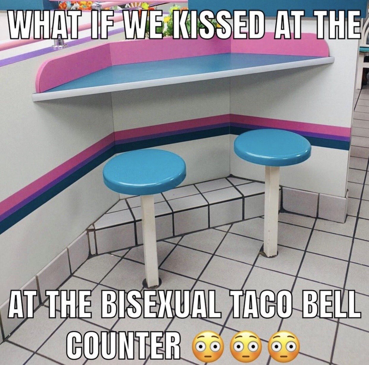The image displays a corner seating area inside a Taco Bell restaurant, featuring two bright blue round stools, white tiled flooring, and a counter booth with pink, purple, and blue trim along the walls that perfectly matches the color palette of the bisexual pride flag. Overlaid bold white text at the top reads 'WHAT IF WE KISSED AT THE', while text at the bottom continues 'AT THE BISEXUAL TACO BELL COUNTER' followed by three wide-eyed, pleading face emojis. The meme uses the classic viral 'what if we kissed at [niche/absurd location]' flirty joke format, leaning into the coincidence that this Taco Bell's interior matches the bisexual pride flag to create a humorous, relatable joke for queer online communities.
