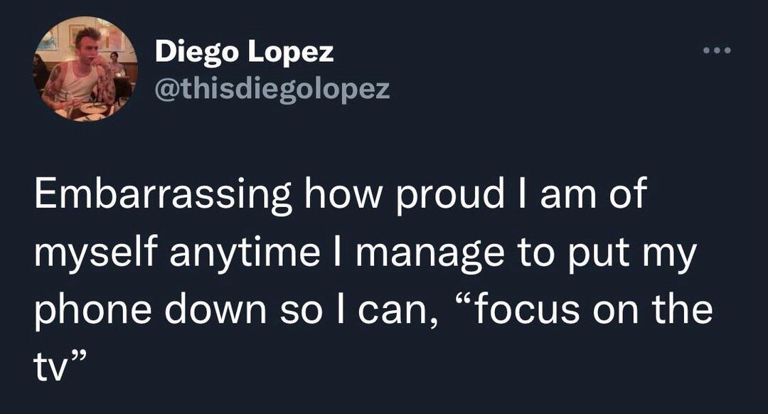 This is a screenshot of a public post from X (formerly Twitter). The post text jokes about the relatable modern experience of feeling disproportionately and almost embarrassingly proud of oneself for completing the very small, basic task of putting down a mobile phone to be able to focus on watching television, highlighting how ubiquitous smartphone distraction has become in daily life. A profile photo of the post author appears at the top left of the screenshot.