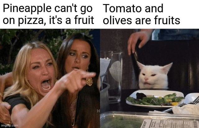 A two-panel meme contrasting a fruit-on-pizza debate. Left panel: Two women, one aggressively pointing and the other looking shocked, with text 'Pineapple can't go on pizza, it's a fruit'. Right panel: A white cat sitting at a dining table with a salad, appearing unimpressed, with text 'Tomato and olives are fruits'. The joke highlights the hypocrisy of opposing pineapple (a fruit) on pizza while accepting tomatoes and olives (also fruits) as standard toppings.