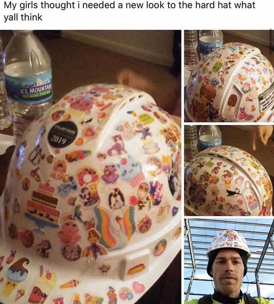 This is a collage of four photographs showcasing a standard white construction hard hat that has been completely covered in a wide variety of colorful, whimsical, childlike stickers. The stickers feature cute characters, unicorns, cakes, animals, and playful designs, creating a stark, humorous contrast between the hard hat's functional, industrial purpose and its new, playful aesthetic. 

The collage includes:
1. A front-angle shot of the hat next to an Ice Mountain water bottle.
2. A top-right close-up of the hat's side.
3. A bottom-left shot showing more sticker details.
4. A bottom-right photo of a man (presumably the poster) wearing the decorated hard hat at a construction-style worksite with metal beams overhead.

The accompanying text asks viewers for their opinion on the new look. The joke comes from the unexpected combination of a tough work safety item with cute, child-appropriate decorations, implying the hat was modified by the poster's daughters or young family members, creating a wholesome, lighthearted moment.