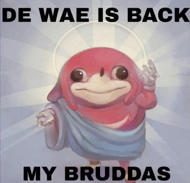 The image features an animated red character resembling Ugandan Knuckles, a popular meme character derived from Sonic the Hedgehog's Knuckles. The character is draped in a light blue cloth, with a white halo floating above its head and a soft, radiant sunburst background in shades of light blue and white. It has large, round, expressive eyes with small pupils, a wide, smiling mouth, and a rounded snout. The character is posed with its left hand raised, index finger pointing upwards, and its right hand slightly extended forward, as if addressing an audience. Bold, uppercase black text is displayed at the top of the image reading 'DE WAE IS BACK' and at the bottom reading 'MY BRUDDAS', referencing the iconic phrases from the Ugandan Knuckles meme.