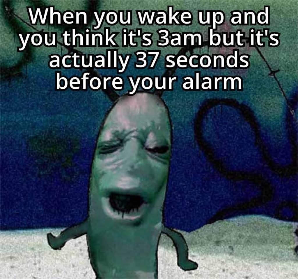 This single-panel meme features a surreal, tired-looking green worm-like humanoid character with a pained, exhausted, half-asleep expression and small outstretched limbs, set against a grungy dark blue and green spray-painted background. Overlaid white text at the top reads 'When you wake up and you think it\'s 3am but it\'s actually 37 seconds before your alarm', humorously depicting the universally relatable frustrating experience of waking up extremely shortly before your scheduled alarm, losing the last tiny bit of rest you expected to get. The character\'s miserable expression perfectly conveys the annoyance and exhaustion of this common morning situation.