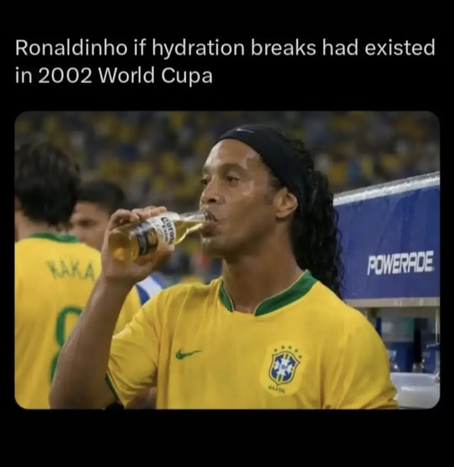 This is a humorous sports meme featuring a photograph of Brazilian football legend Ronaldinho wearing the iconic yellow 2002 Brazil national team jersey. He is shown drinking from a glass bottle of Corona beer, positioned next to a sideline Powerade (official sports drink sponsor) stand. The text at the top of the meme reads 'Ronaldinho if hydration breaks had existed in 2002 World Cupa' (with an intentional or accidental typo of 'Cup' as 'Cupa'). The joke plays on Ronaldinho's widely publicized reputation for enjoying partying and drinking alcohol off the pitch, implying that he would have used official match hydration breaks to drink beer instead of the intended sports drinks if such breaks existed during the 2002 World Cup. Fellow Brazilian player Kaká is visible in the background wearing a matching Brazil jersey with his name and number 8 printed on the back.