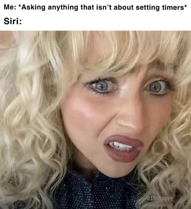 A meme criticizing Siri's functionality beyond basic tasks. The top text reads 'Me: *Asking anything that isn’t about setting timers* Siri:' followed by a close-up image of a person with curly blonde hair, wide eyes, and a surprised/confused expression, visually representing Siri's perceived inability to handle complex queries. A watermark '010RUSTY' is visible in the bottom right corner.
