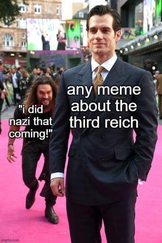 This remixed meme uses the popular Jason Momoa sneaking behind Henry Cavill template. Henry Cavill stands calmly in the foreground on a pink premiere red carpet in a formal suit, with overlaid text reading 'any meme about the third reich'. Behind him, Jason Momoa creeps forward with a mischievous grin, with overlaid text reading '"i did nazi that coming!"'. The core joke is a homophonic pun where 'Nazi' is substituted for 'not see' to create the phrase 'I did not see that coming', an extremely common, overused corny joke that reliably appears in comments or responses to any online content referencing the Third Reich or Nazi Germany.