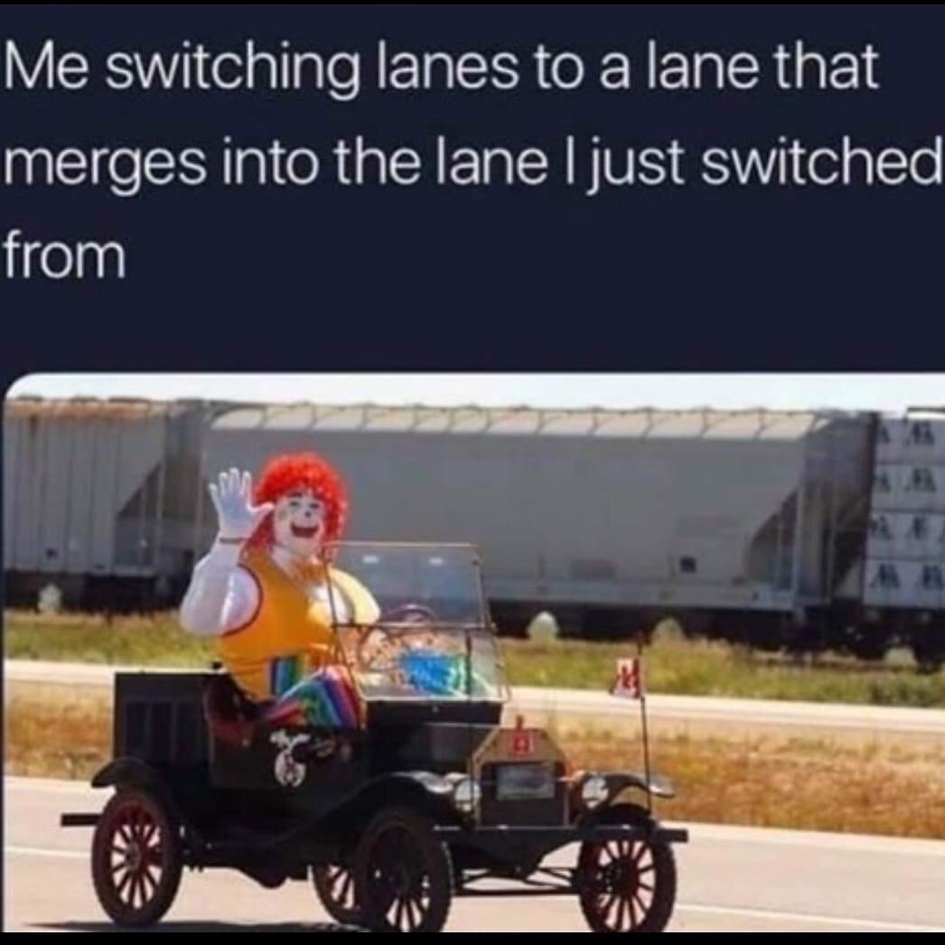 The meme consists of two parts: white text at the top on a dark background reads 'Me switching lanes to a lane that merges into the lane I just switched from', and below is a photograph of a person in a Ronald McDonald mascot costume driving a tiny vintage open-top car on a road, waving enthusiastically with a wide, cheerful smile, with a long freight train visible on the parallel track behind him. The humor comes from the relatable driving frustration of making an effort to switch lanes to get ahead, only to find the new lane immediately merges back into the original lane you left, rendering your effort useless. The clown's over-the-top cheerful wave is used sarcastically to represent the silly, annoyed feeling of this common driving mishap.