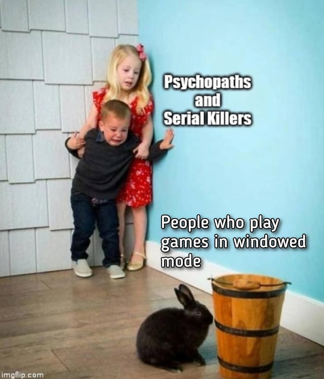 This meme uses the popular 'frightened children cornered by a harmless small animal' template. Two young children, a crying young boy held back by a distressed blonde girl, are pressed against the corner of a wall looking terrified, and are labeled 'Psychopaths and Serial Killers'. In front of them, a calm black rabbit sits next to a wooden bucket on the floor, labeled 'People who play games in windowed mode'. The joke is an absurd, hyperbolic comparison that frames people who choose to play video games in windowed mode as so unusually strange and intimidating that even violent psychopaths and serial killers are terrified of them, poking fun at the long-running gaming community debate over preferred display modes (fullscreen vs windowed) for video games.