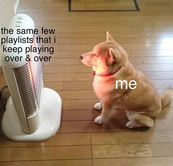 This relatable meme shows a real tan Shiba Inu sitting contentedly on a wooden floor in front of a glowing electric space heater, with its eyes closed soaking up the warmth. Text labels the heater as 'the same few playlists that i keep playing over & over' and the Shiba Inu as 'me', drawing a comparison between the cozy comfort of the heater and the comforting feeling people get from repeatedly listening to their favorite, familiar playlists instead of new music.
