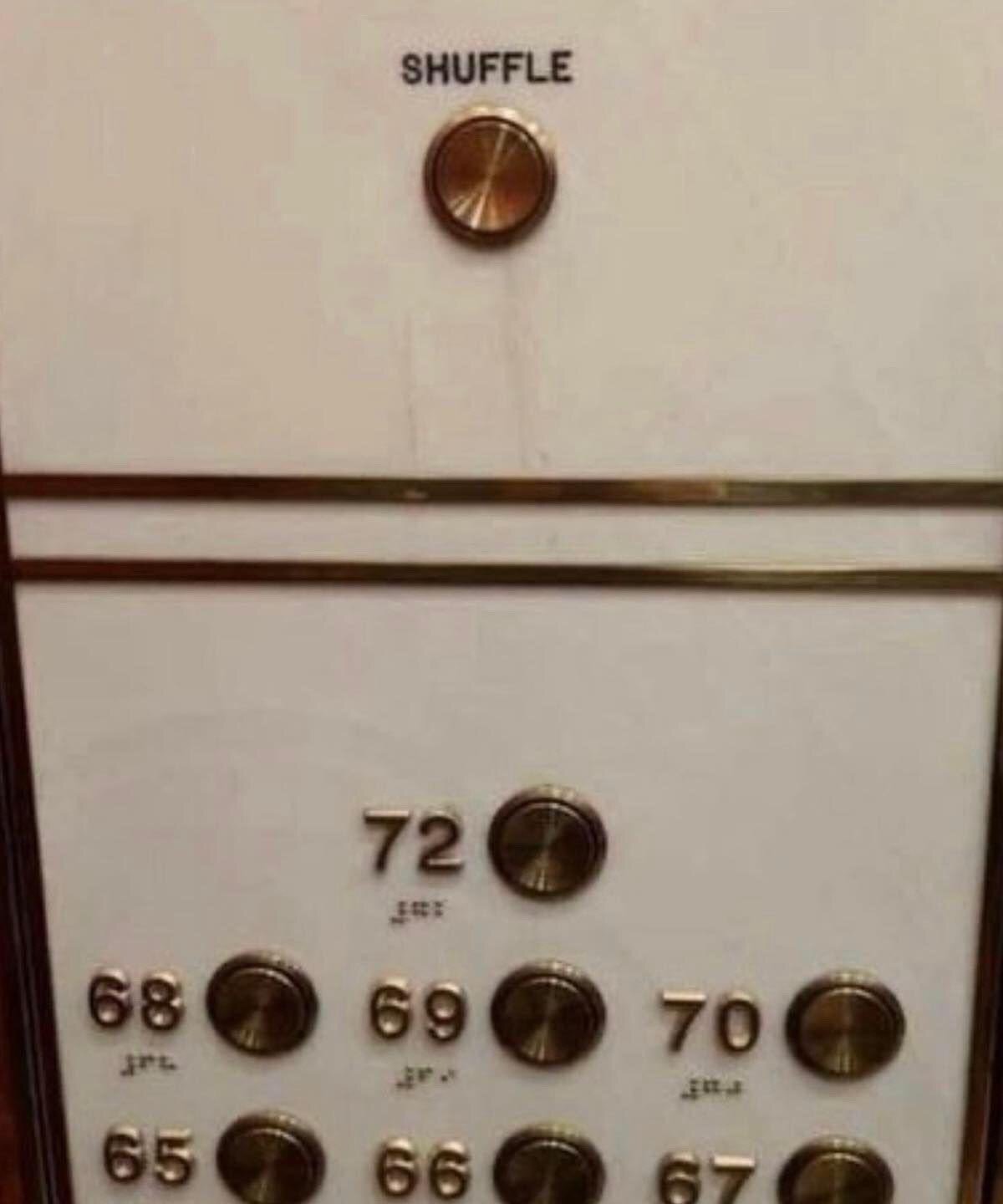 This humorous edited image shows a realistic brass and white elevator control panel for a high-rise building, with numbered floor buttons for floors 65 through 72 visible, each paired with braille labels for accessibility. A fake, out-of-place round brass button labeled 'SHUFFLE' has been added above the standard floor selection options. The joke comes from applying the common 'shuffle' feature used for media playlists or card games to elevator operation, implying pressing the button would send the elevator to a random unselected floor, which is an absurd and deeply impractical feature for an elevator to have.