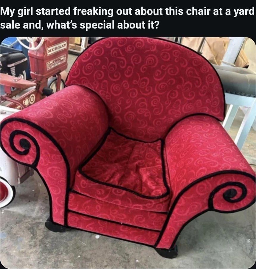 The image displays a vibrant red upholstered armchair with black trim and swirling fabric patterns, presented at a yard sale. Text overlaid at the top of the image reads: 'My girl started freaking out about this chair at a yard sale and, what's special about it?'. The chair is nearly identical to the famous 'Thinking Chair' from the beloved 1990s/2000s children's television series *Blue's Clues*, which is the implicit punchline explaining the girlfriend's excited reaction. Background items include a vintage red Murray branded ride-on toy car and other miscellaneous yard sale goods on a concrete floor.