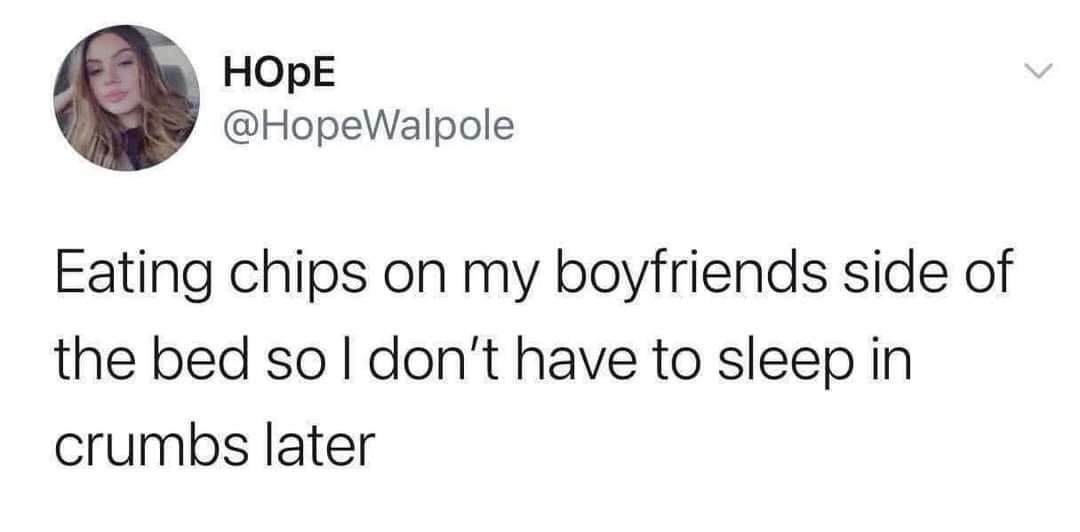 This is a screenshot of a public X (formerly Twitter) post from user @HopeWalpole. The post features a relatable, humorous joke: the poster shares that she eats chips on her boyfriend's side of the bed so she does not have to sleep in crumbs later, choosing to shift the snack mess to her partner instead of avoiding eating in bed or cleaning up the crumbs. The screenshot includes the poster's profile picture of a young woman, her display name 'HOpE', and her X handle.