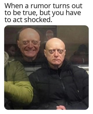 The meme features two real people. The front person has a neutral, serious expression, while the person behind them is smiling. At the top, there's text that reads: 'When a rumor turns out to be true, but you have to act shocked.' The contrast between the front person's feigned neutrality and the behind person's genuine amusement humorously illustrates the scenario of pretending to be shocked by a true rumor.