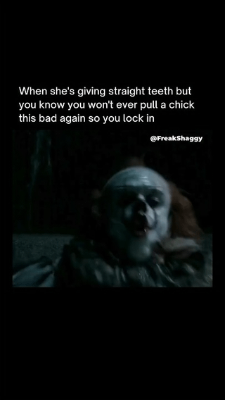 This dark humor meme displays a low-light, slightly blurry shot of the horror villain Pennywise the Dancing Clown from the *IT* film franchise, making an unpleasant, strained facial expression. Above the character, white text reads 'When she's giving straight teeth but you know you won't ever pull a chick this bad again so you lock in'. The joke makes fun of extreme romantic desperation, implying the poster is so unattractive or unlucky in dating that they are willing to commit to a partner as unpleasant/terrifying as Pennywise, reasoning they will never be able to get even a similarly bad partner again in the future. A watermark for the creator @FreakShaggy is visible in the upper right corner of the image.