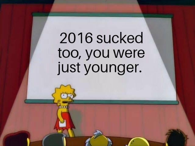 An image featuring Lisa Simpson from 'The Simpsons' standing in front of a projection screen displaying the text: '2016 sucked too, you were just younger.' Lisa is in her iconic red dress, holding a piece of paper, and appears to be presenting to an audience (partially visible Simpsons characters) in a classroom or lecture-style setting. The meme humorously comments on the common complaint of 'worst year ever' by suggesting 2016 was similarly bad, but people were younger and less aware.