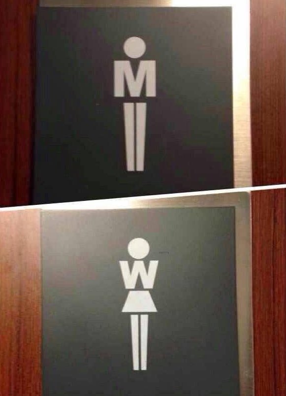 This image is a vertical composite of two photographs of restroom door signs. The upper sign marks the men's restroom: the torso section of the standard male restroom pictogram is replaced by a capital letter 'M', paired with the standard straight leg design for male figures. The lower sign marks the women's restroom: the torso section of the standard female restroom pictogram is replaced by a capital letter 'W', paired with a triangular skirt design for female figures. The design uses the common 'M' (Men) and 'W' (Women) restroom abbreviations as an integrated part of the pictogram, creating a clever, intuitive visual pun.