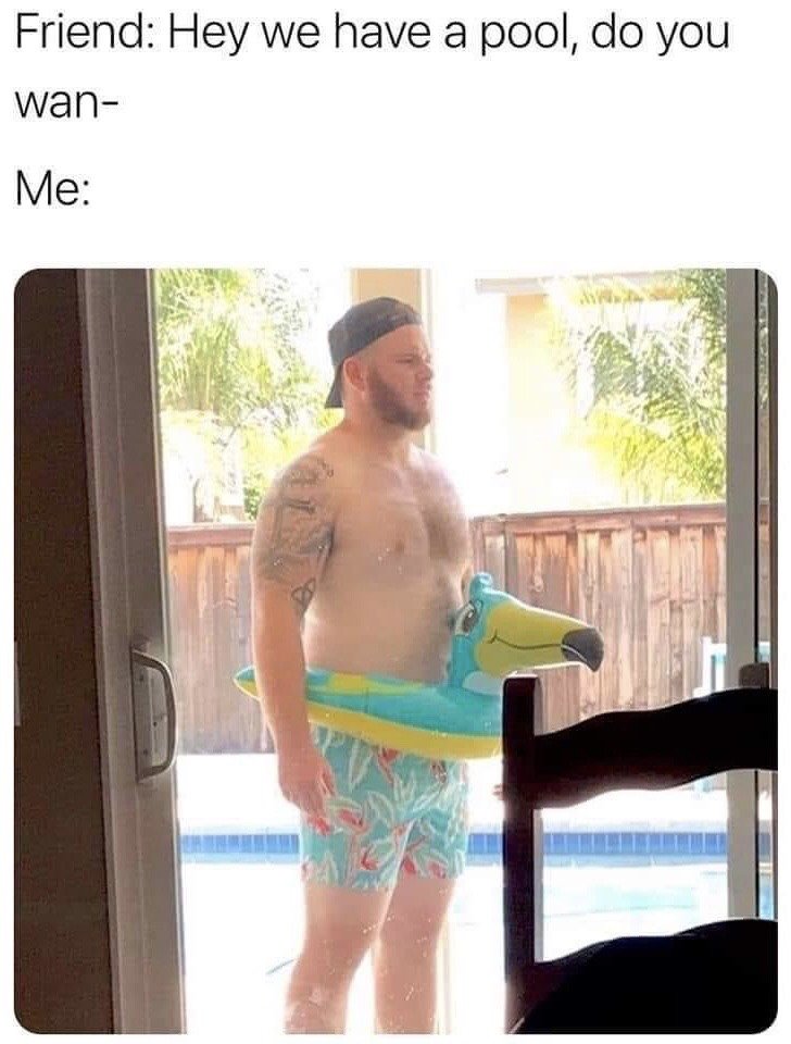 The meme is structured with text at the top setting up a relatable humorous scenario: a friend is cut off mid-sentence while asking 'Hey we have a pool, do you wan-', followed by the label 'Me:'. Below the text is a photograph of a shirtless heavyset man with a backward black baseball cap, arm tattoos, tropical print swim trunks, and a large toucan-shaped inflatable pool float already worn around his waist. He stands at a sliding glass door leading to a backyard with a visible swimming pool, appearing fully prepped and waiting to be invited in before the friend even finished their question. The comedy comes from the absurdly over-eager, over-prepared reaction to a casual pool invite.
