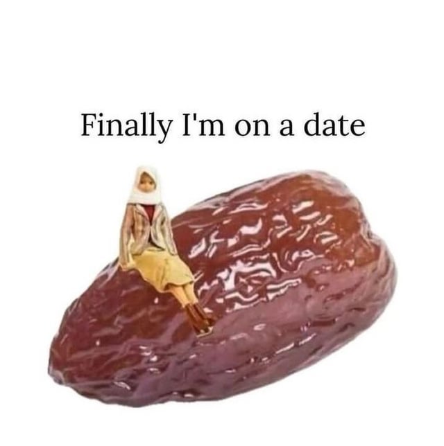 A meme image depicting a small figurine of a person (likely a woman) sitting casually on top of a large, shiny date fruit. Above the figurine, there is a prominent text overlay that reads 'Finally I'm on a date.' The humor relies on a pun where 'date' refers both to a social outing between individuals and the sweet fruit, creating a playful scenario where the figurine is literally 'on a date' (the fruit).