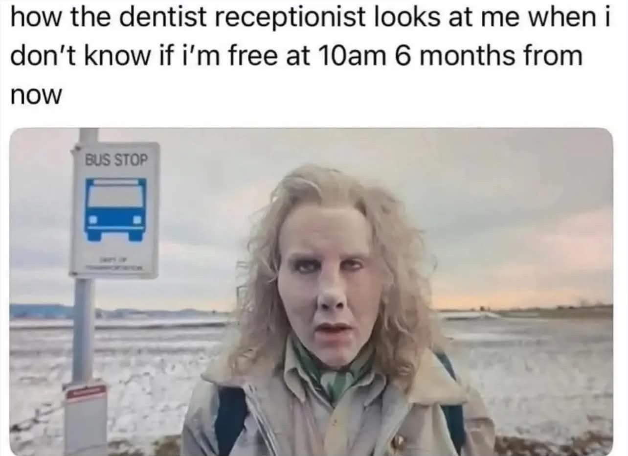 This meme consists of text at the top above a viral photograph. The top text reads 'how the dentist receptionist looks at me when i don't know if i'm free at 10am 6 months from now'. The image below shows a woman with pale, frost-covered looking skin, messy blonde curly hair, and a blank, judgmental, annoyed expression standing at a bus stop in a snowy, open winter landscape. The joke humorously highlights the common relatable frustration of dental offices asking patients to schedule appointments extremely far in advance, portraying the receptionist as unreasonably annoyed at the patient for being unable to confirm their availability half a year ahead of time.
